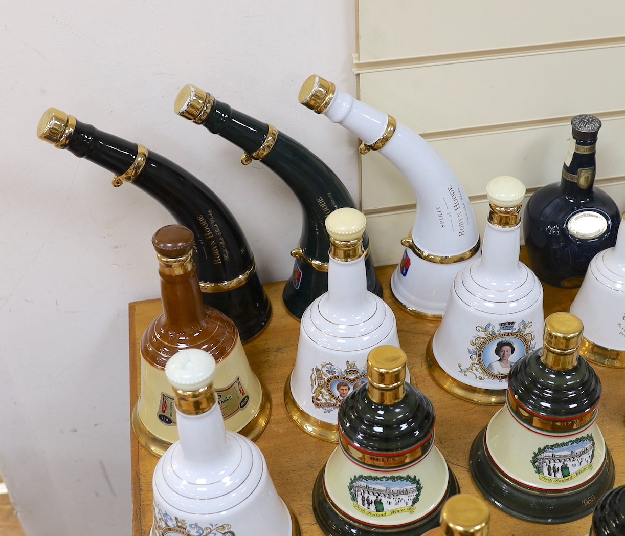 Four Wade commemorative porcelain 70cl bottles of Bells whisky, a miniature porcelain bottle of bells whisky, two miniature ‘beer pump’ bottles of mead and a large quantity of empty porcelain decanters